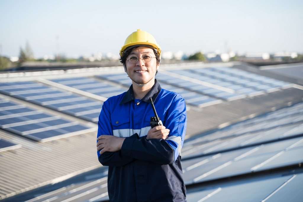 Portrait of Asian engineer in front of solar panels