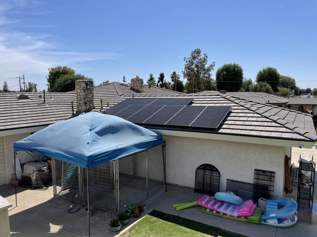 various solar panels installed on roof with blue sky background