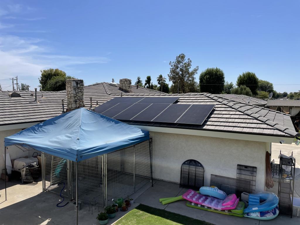 various solar panels installed on roof with blue sky background