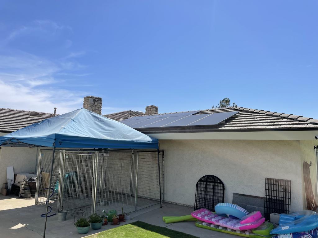 black solar panels on top of house roof in Bakersfield, CA