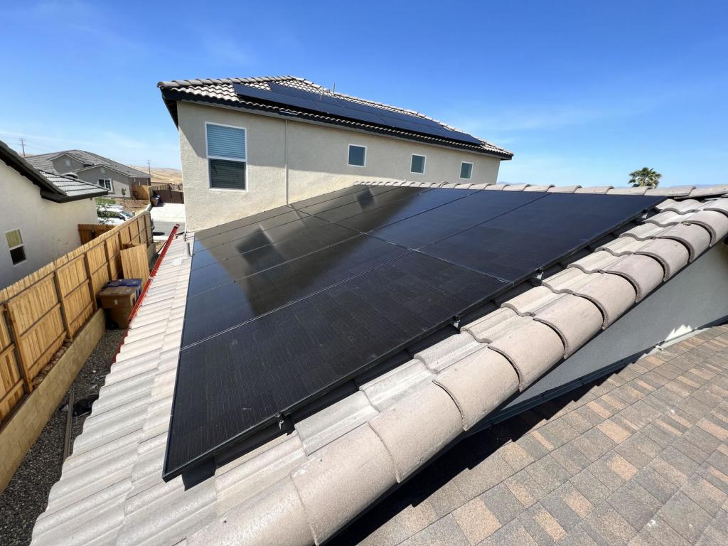 various black solar panels installed on roof with tiles in Bakersfield, CA